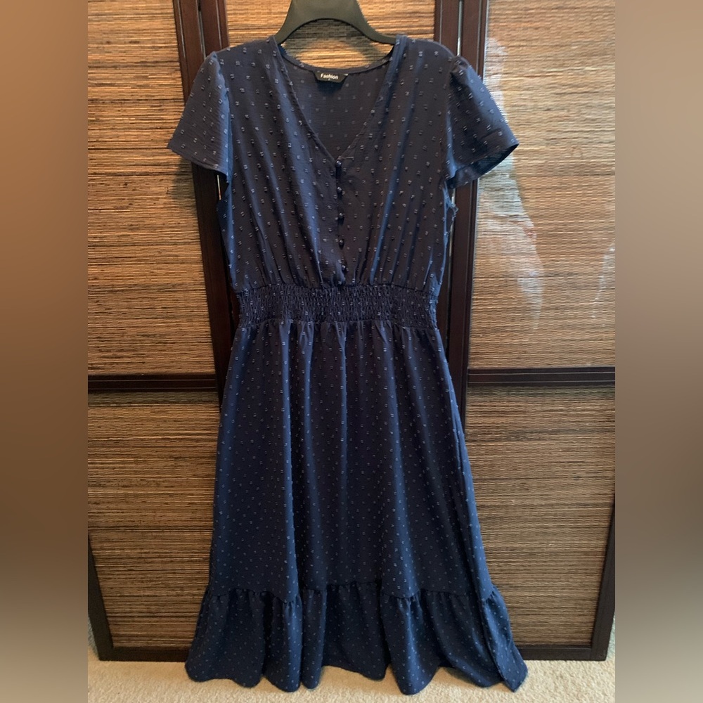 Blue short sleeve midi length dress.